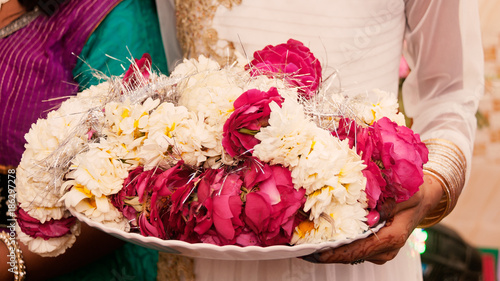 Flowers on plate during Garland Ceremony in Indian wedding. © Prashant ZI