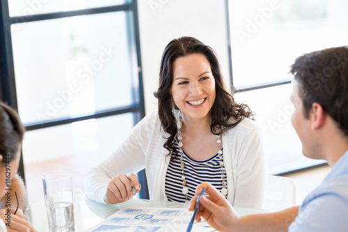 Image of business partners discussing documents and ideas