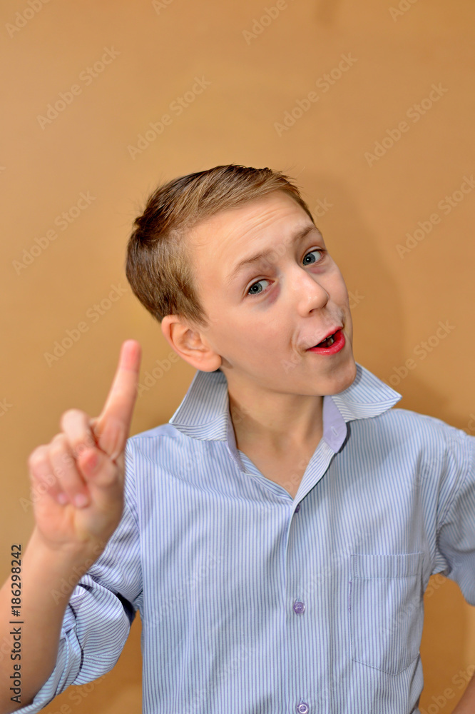 emotional boy with fashion haircut in light blue shirt in studio emotional boy with fashion haircut in light blue shirt in studio