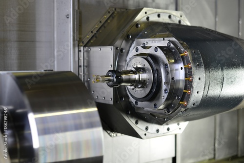 The 5-axis CNC machine while cutting the sample part of turbine.The spindle of 5 axis CNC machining center white cutting turbine sample part.