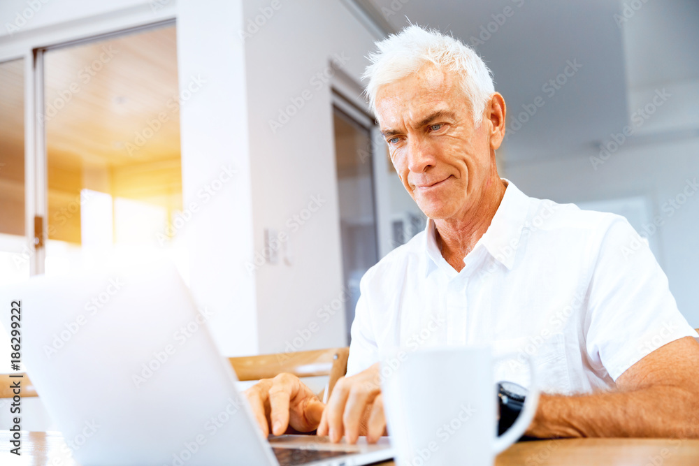 Man working on laptop at home Man working on laptop at home