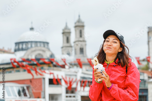 Photography Young woman eating turkish fast food in Istanbul, Turkey