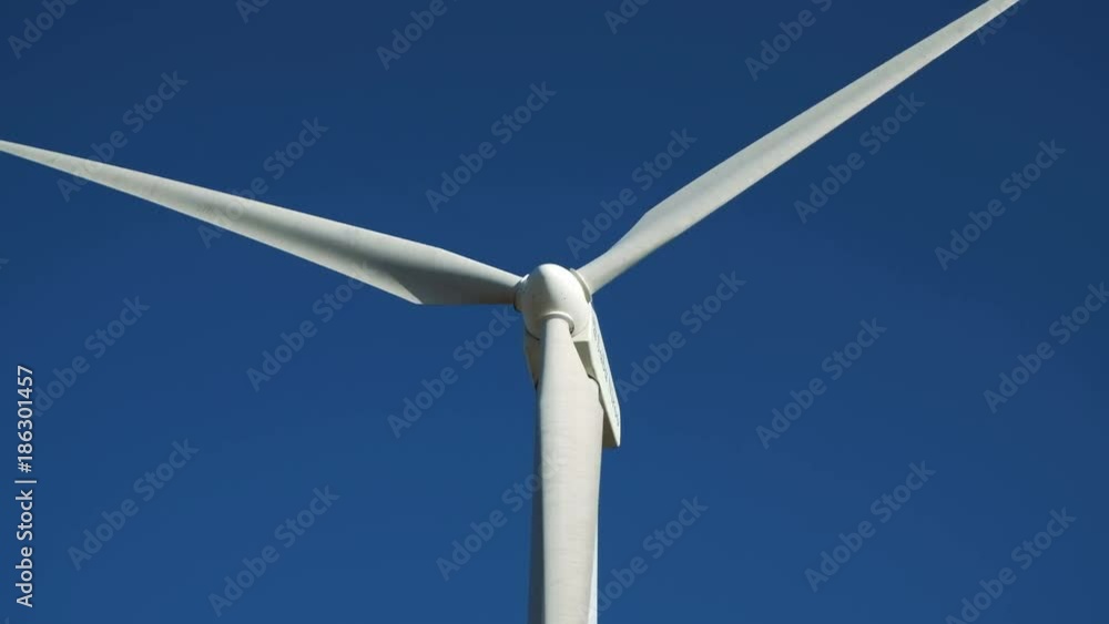 Concept of clean windpower - solution many problems: earth ecological pollution, changing weather and global warming. Windfarm construction spin closeup, white wind-turbine against colorful skyline Concept of clean windpower - solution many problems: earth ecological pollution, changing weather and global warming. Windfarm construction spin closeup, white wind-turbine against colorful skyline