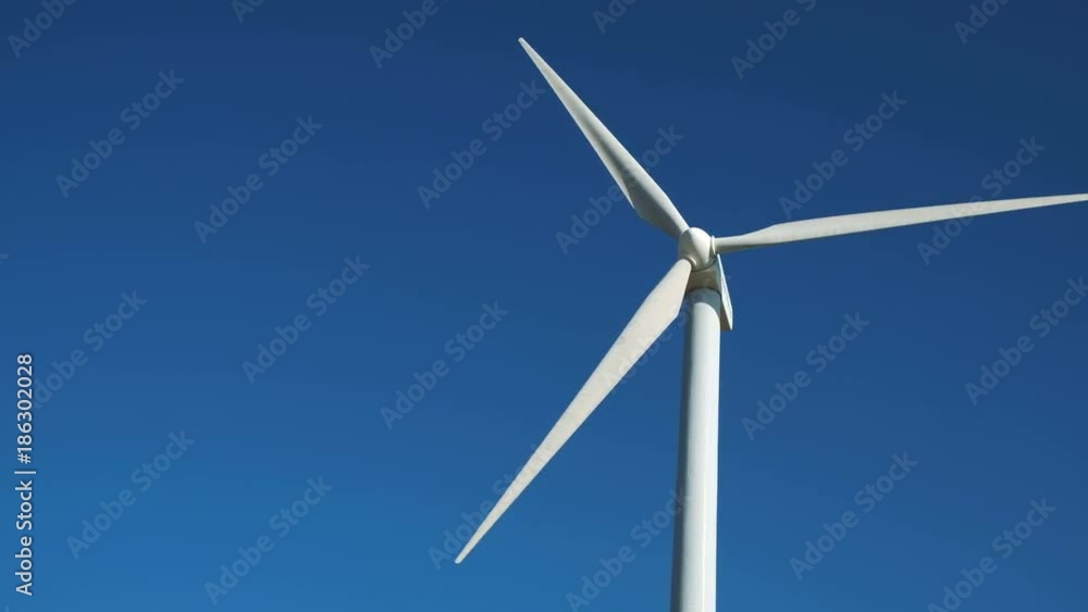 Concept of clean windpower - solution many problems: earth ecological pollution, changing weather and global warming. Windfarm construction spin closeup, white wind-turbine against colorful skyline Concept of clean windpower - solution many problems: earth ecological pollution, changing weather and global warming. Windfarm construction spin closeup, white wind-turbine against colorful skyline
