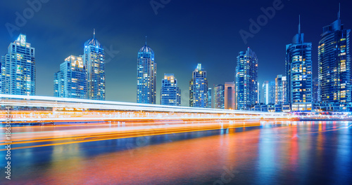 Fototapeta Naklejka Na Ścianę i Meble -  Evening on busy canal and promenade in Dubai Marina,Dubai,United Arab Emirates