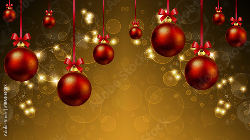 Hanging Christmas balls and festive background with highlights and bokeh