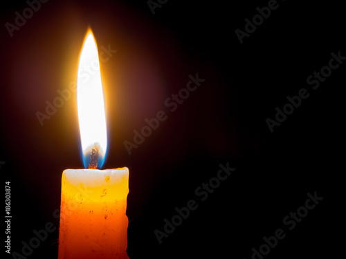 Fotografija One Candle light on black background, Candlelight shines light into the destination