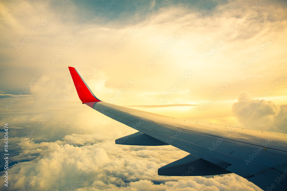 Fototapeta premium Morning sunrise with Wing of an airplane. Photo applied to tourism operators. picture for add text message or frame website. Traveling concept