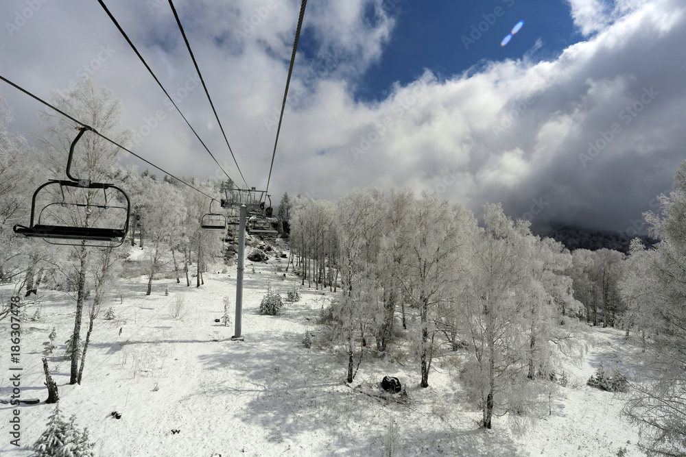 Sunny winter day a panoramic view of the ski lift.