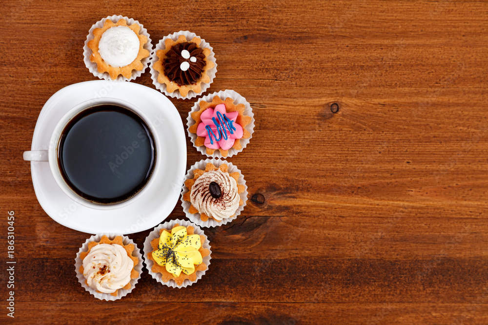 Closeup shot of small cup of coffee with colorful cupcakes. Flat lay Closeup shot of small cup of coffee with colorful cupcakes. Flat lay