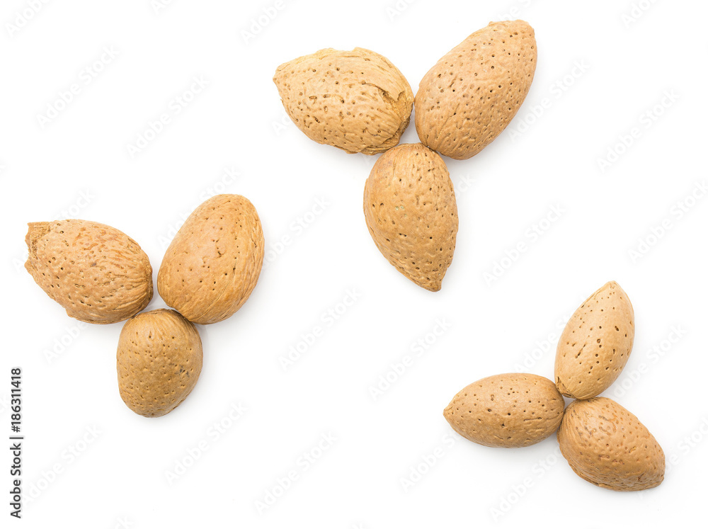 Three almonds top view isolated on white background unshelled nuts flowerlike. Three almonds top view isolated on white background unshelled nuts flowerlike.