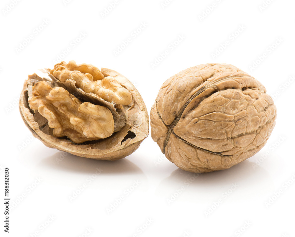 Two walnuts isolated on white background one open and whole. Two walnuts isolated on white background one open and whole.