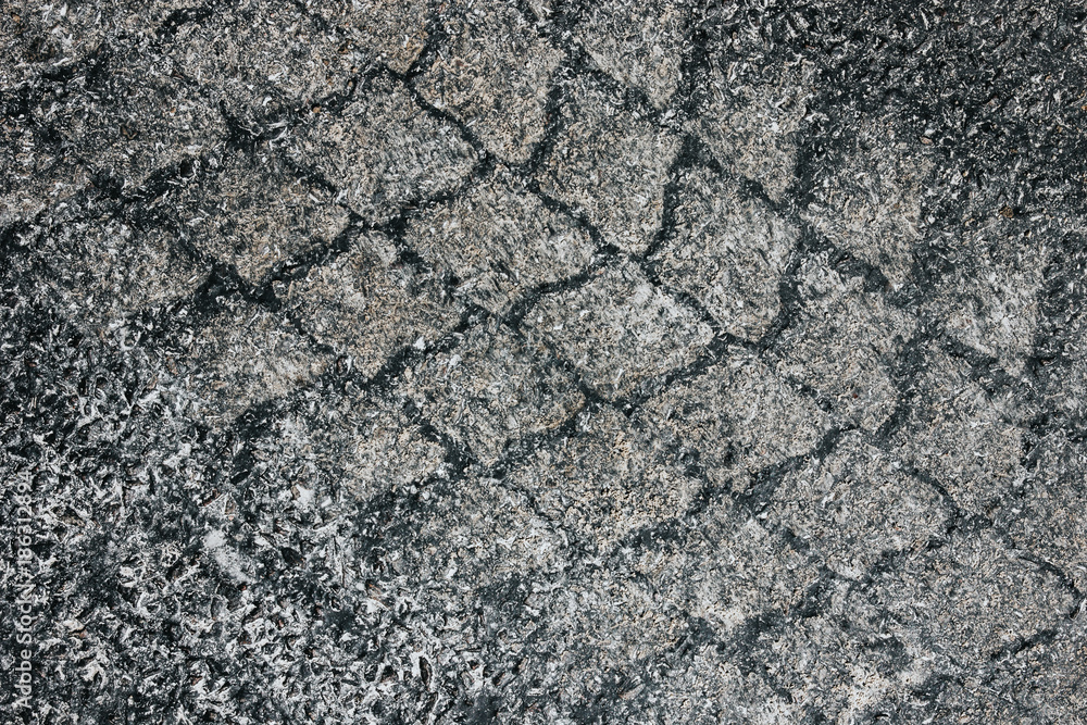 Sandy tyre mark on black asphalt closeup pattern. Sandy tyre mark on black asphalt closeup pattern.