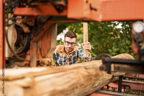Young working man at sawmill