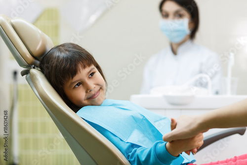 Child patient having doctor's appointment with mother's support