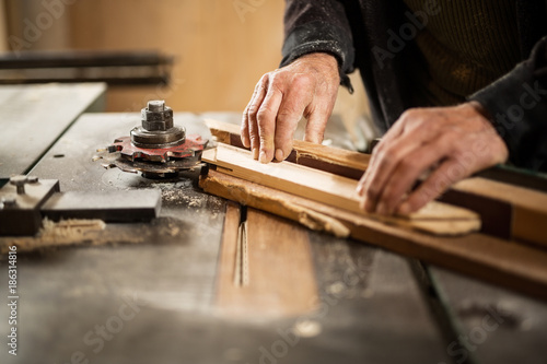 Senior man cutting wood