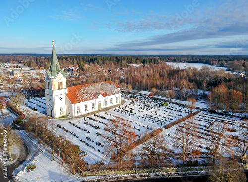 Swedish small village in winter - view with church and lake photo