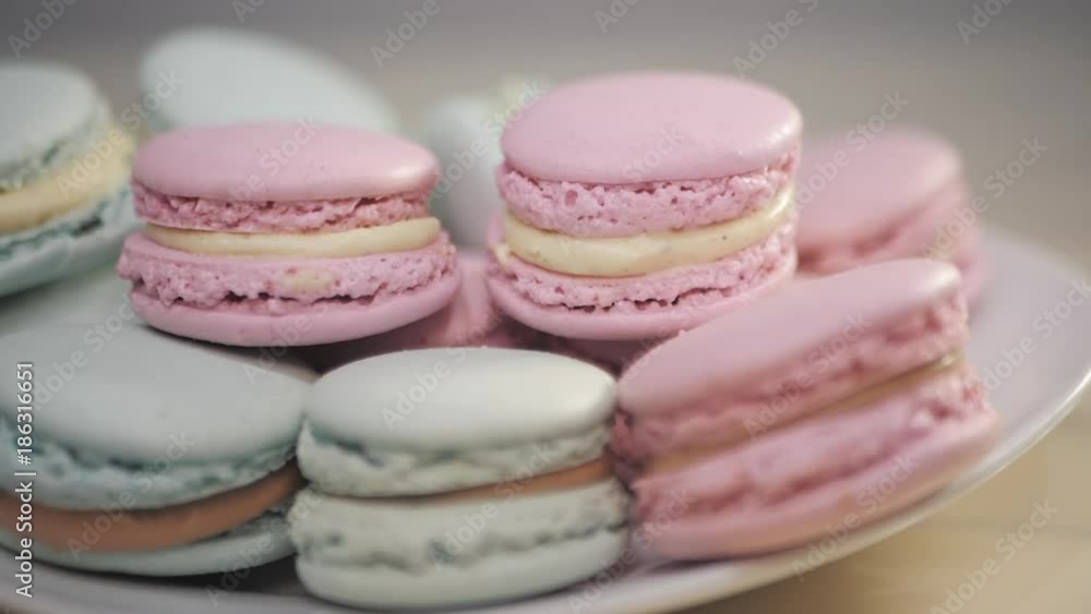 French macarons - meringue cookies with ganache or buttercream filling. Colorful macaroons rotating, horizontal view , slow motion French macarons - meringue cookies with ganache or buttercream filling. Colorful macaroons rotating, horizontal view , slow motion
