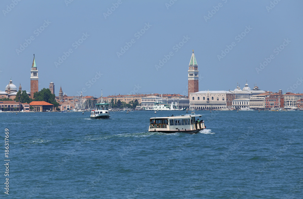cityscape View of the island of VENICE in Italy with the ancient palaces and bell towers from the ferry boat called Vaporetto in italian language