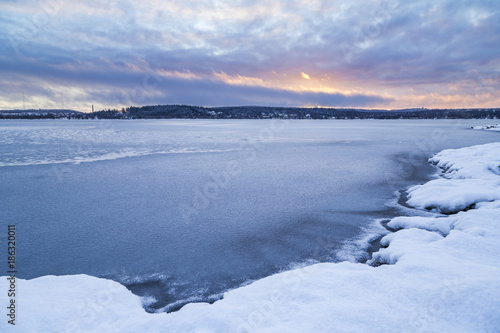 Beautiful blue moment next to lake in winter landscape from Finland