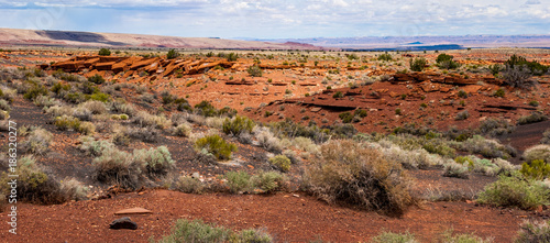 A Desert Landscape of Rock Formations and the Painted Desert in the Distance Along the Sunset Crater Scenic Drive in Arizona