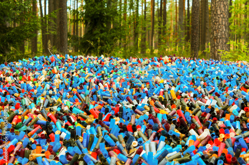 Many empty shotgun shells of various colors: blue, red, orange, yellow