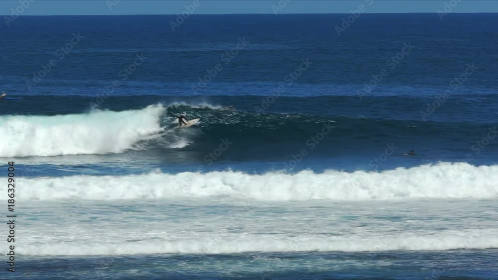 a surfer rides a wave the famous big wave location at margaret river in western australia a surfer rides a wave the famous big wave location at margaret river in western australia