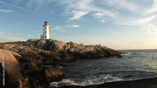 Low angle, people around scenic Nova Scotia lighthouse