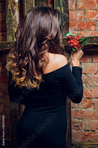 portrait of beautiful brunette woman holding in her hands bouquet of wild flowers. Enjoying sun. Happiness and love concept. Beautiful flowers. Romantic mood. Sunny day on the nature photo