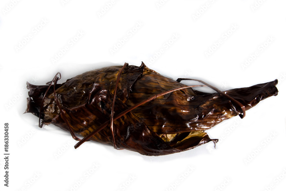 Fototapeta premium Grill fish gilt-head bream wrapped in banana leaf isolated on white background. Sparus aurata.