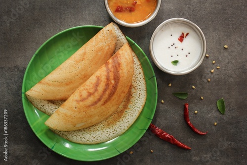 Dosa - South Indian Breakfast crepes served with chutney and sambar, top view photo