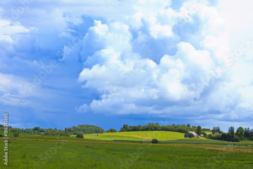 Fototapeta Naklejka Na Ścianę i Meble -  Cloudy above the country farm.