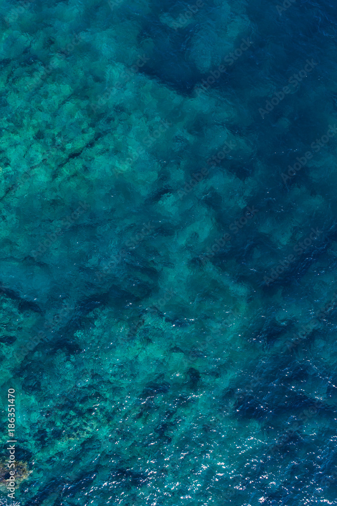 Aerial view on green waves, seabed texture