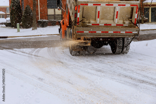 municipal car for sprinkle half the salt and sand on roads with snow machine for sprinkling sand roads photo