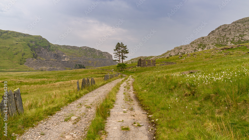 The ruin of Capel Rhosydd near Blaenau Ffestiniog, Gwynedd, Wales, UK - with Cwmorthin Quarry in the background The ruin of Capel Rhosydd near Blaenau Ffestiniog, Gwynedd, Wales, UK - with Cwmorthin Quarry in the background