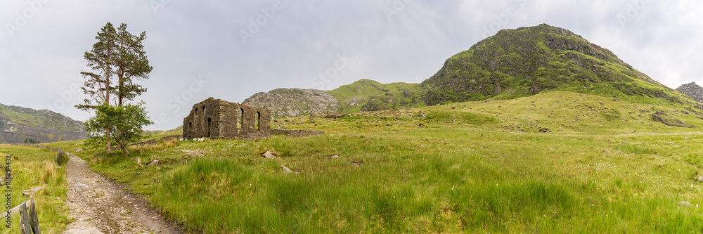 The ruin of Capel Rhosydd near Blaenau Ffestiniog, Gwynedd, Wales, UK - with Moel Yr Hydd in the background