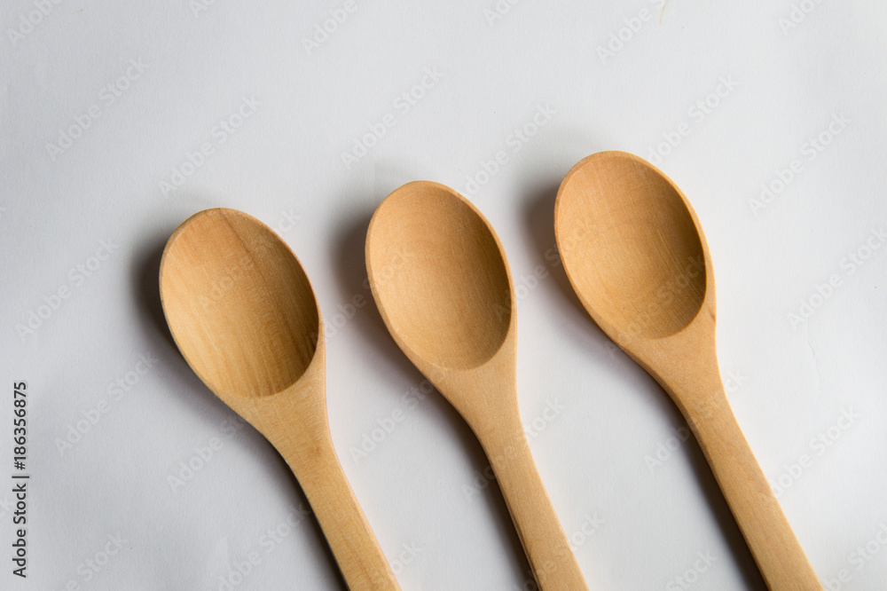 Three teaspoons of natural wood. Isolated on white background. Three teaspoons of natural wood. Isolated on white background.