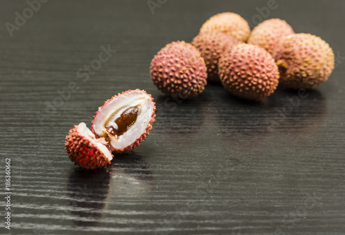 Half-split ripe fruit lychee on the table. photo