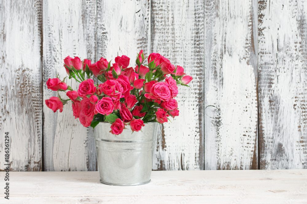 Bouquet of crimson roses in bucket Bouquet of crimson roses in bucket