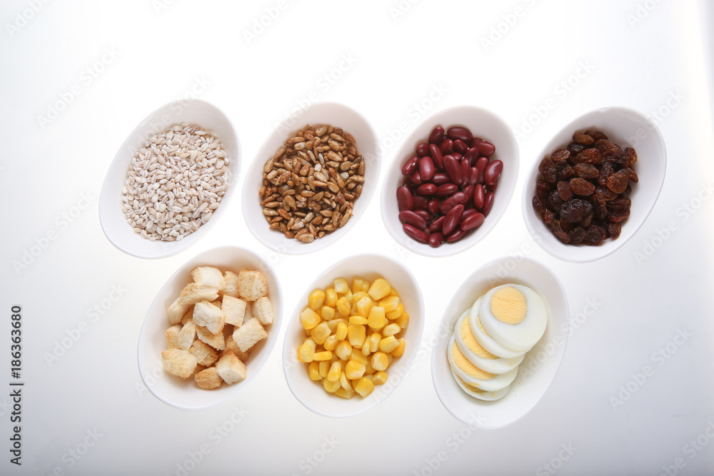 Group of croutons, redbean, boiled eggs,sunflower seed, raisins and corn Group of croutons, redbean, boiled eggs,sunflower seed, raisins and corn