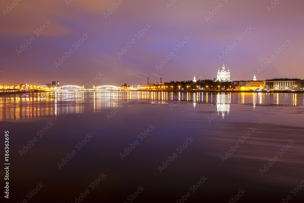 Evening view of the Smolny Cathedral, Bolsheokhtinsky Bridge and the Neva River. St. Petersburg. Russia