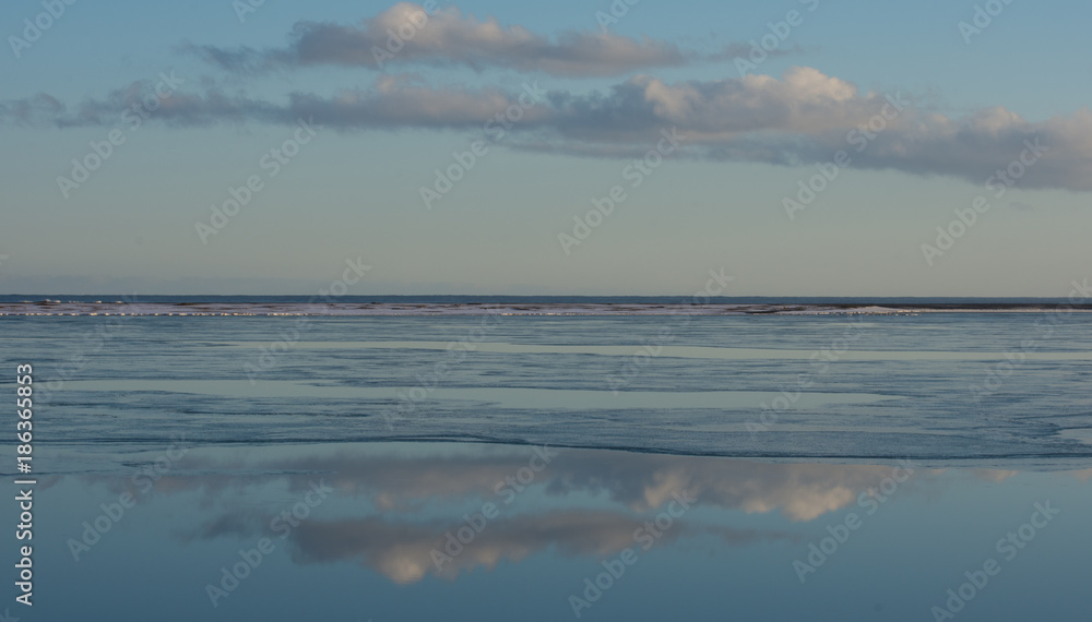 Clouds reflected in sea at low tide Iceland in winter