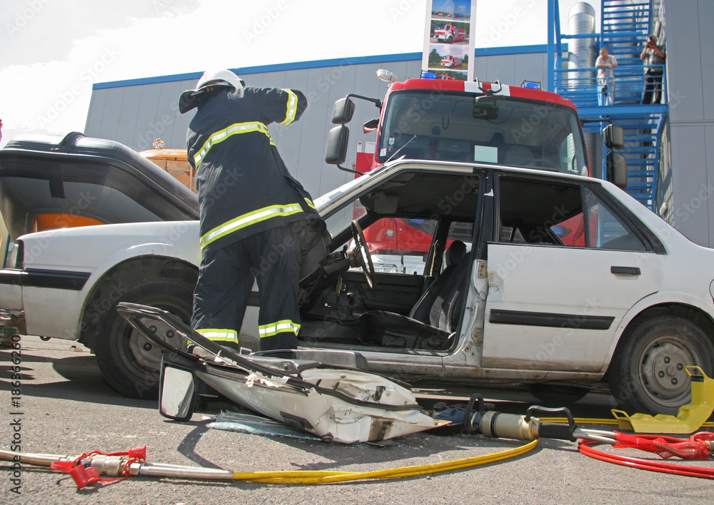 Rescue firefighter in action for saving people from a car crash 