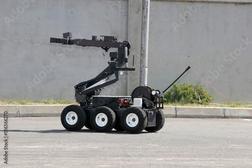 Terrorism. Bomb. Robot. A robot disarm a bomb inside a car of terrorists. Bomb squad robot. 