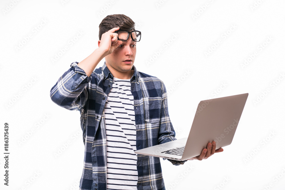 Portrait of serious man with laptop. Man in glasses shocked looking at the laptop isolated on white background Portrait of serious man with laptop. Man in glasses shocked looking at the laptop isolated on white background