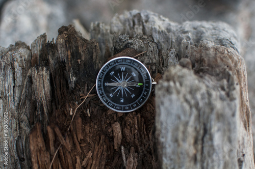 Compass in the hand against mountain. Adventure end travel background.