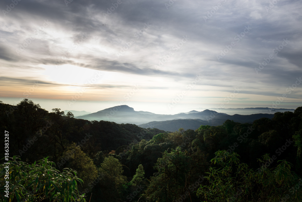 Morning mist in the mountains, bright blue sky, clouds in the foreground. Morning mist in the mountains, bright blue sky, clouds in the foreground.