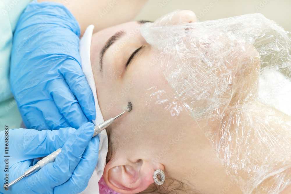 Naklejka premium Deep cleansing of the skin on the female face with tools
