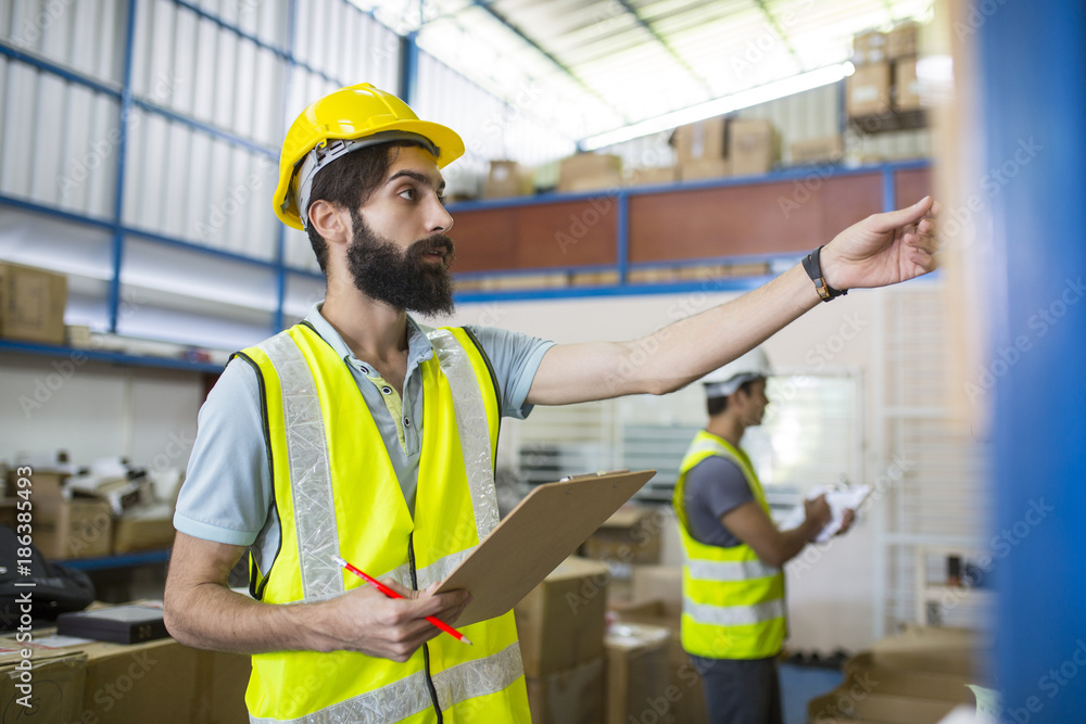 Warehouse worker checking stock products Warehouse worker checking stock products