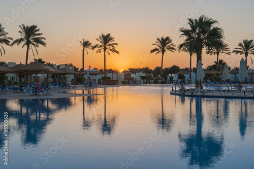 Large swimming pool in a luxury tropical hotel resort at sunrise